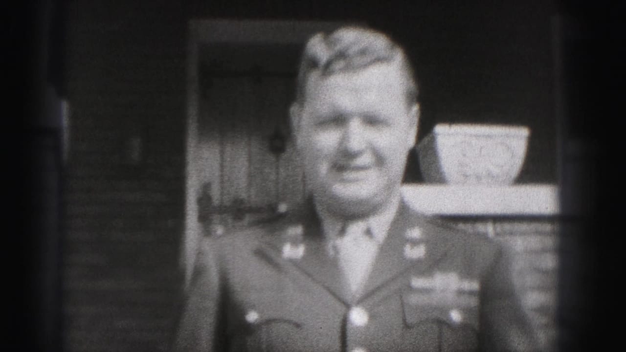 The uniformed man faces the camera and appears to smile outside the New Cumberland residence in the 1946 home movie.