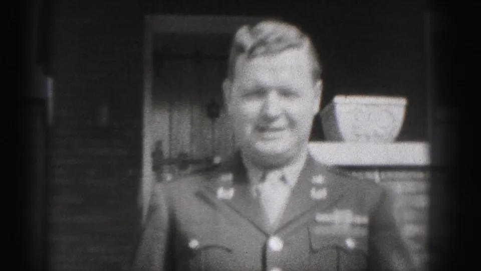 The uniformed man faces the camera and appears to smile outside the New Cumberland residence in the 1946 home movie.