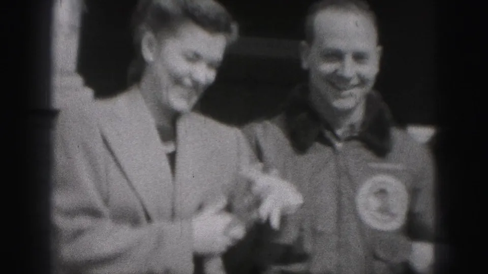 In New Cumberland, Pennsylvania, a woman in a light coat smiles beside a man in a collared shirt during a warm outdoor interaction.
