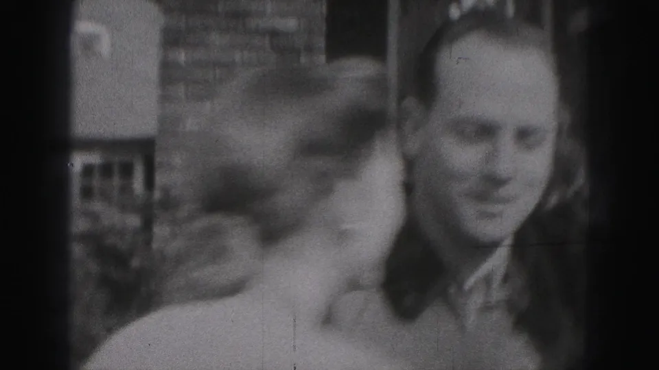 A woman leans close to a smiling man in a 1946 outdoor family-reunion moment in New Cumberland, Pennsylvania.