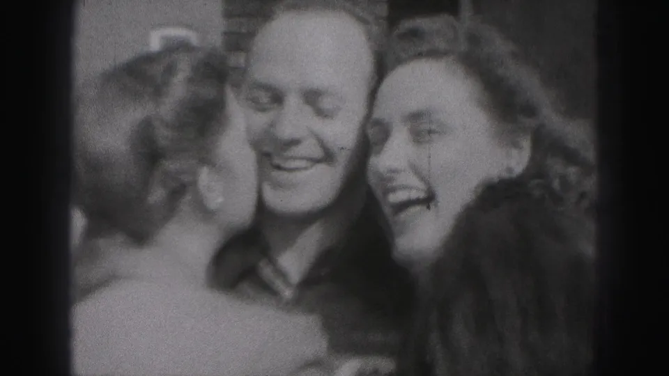 Three adults laugh and lean together in black-and-white 1946 home-movie footage from New Cumberland, Pennsylvania.