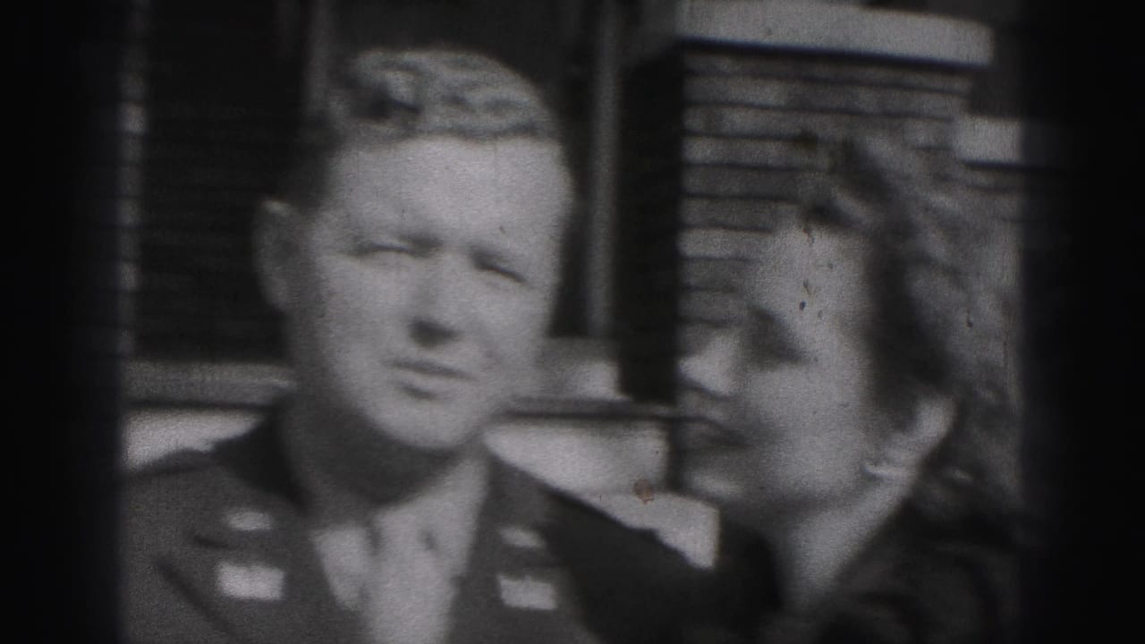 Black-and-white 1946 New Cumberland frame showing a uniformed man and woman joking closely as she raises her hand near him.