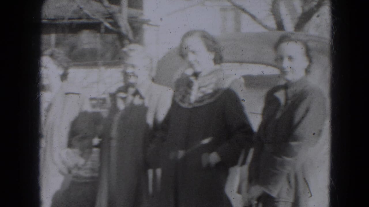 Women in coats and scarves face the camera as other adults and parked cars remain visible in the 1947 Lincoln street scene.