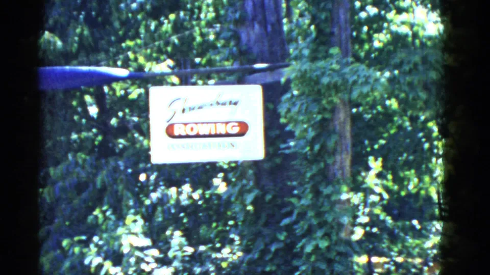 A Boston-area roadside rooming sign appears against foliage in the final 1951 home-movie frame.
