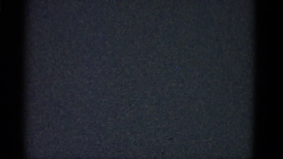 The clip shifts to a dark, grainy 8mm frame with little visible subject detail after the indoor gathering.