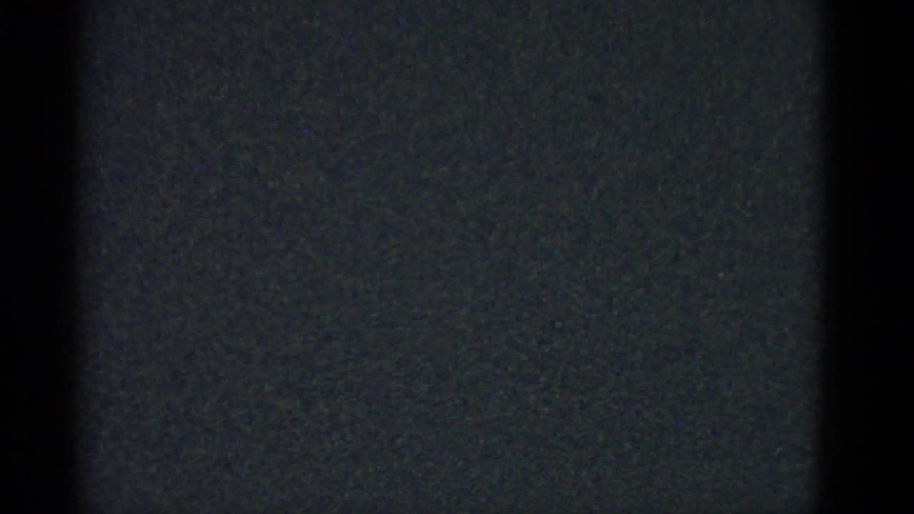 Dark 8mm frame with visible film edge and little discernible subject detail.