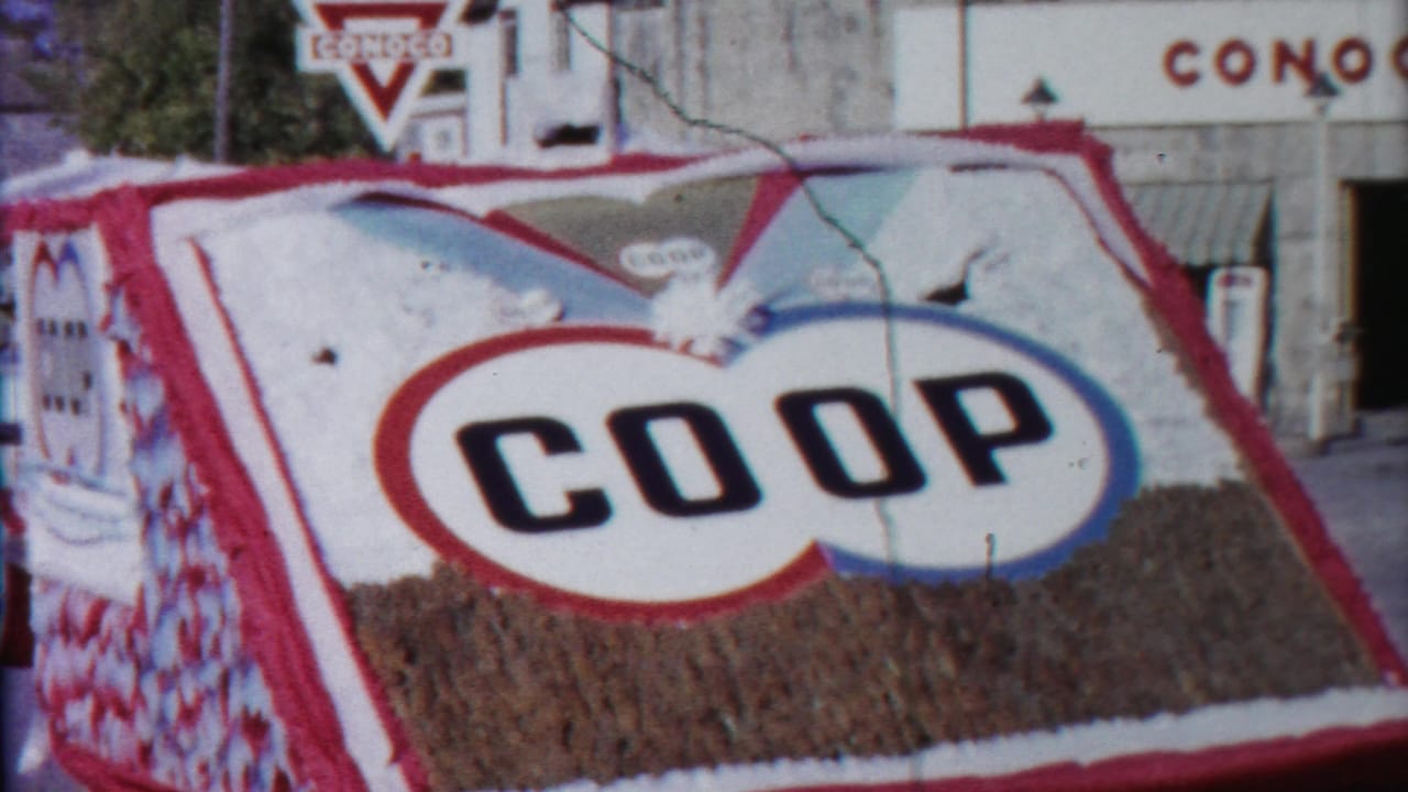 Large COOP float panel with Conoco station signage behind it.