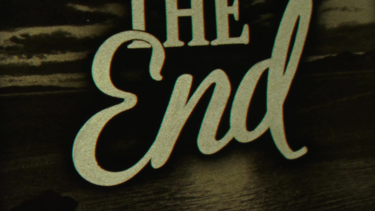 Scripted THE END title card over a dark scenic background.