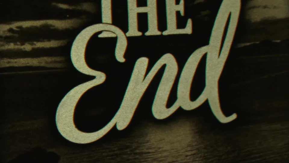 1958 8mm home-movie frame showing a scripted THE END title card over a dark landscape-style background.