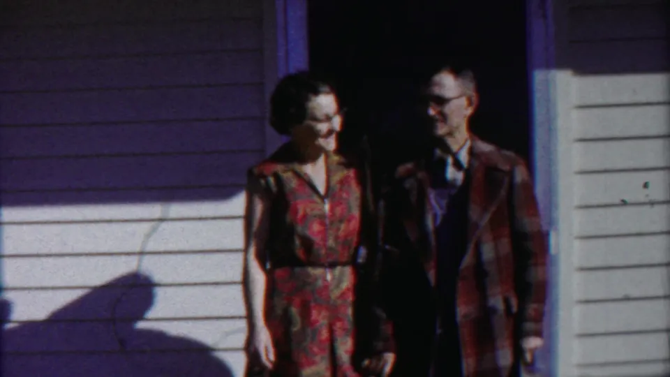 At the end of the clip, the woman turns toward the man as they stand together at the doorway in Cheyenne County, Kansas footage.