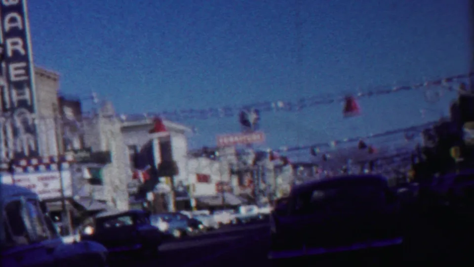 Cheyenne County, Kansas 1958 street scene with classic automobiles, overhead decorations, and the WAREHOUSE theater sign at left.