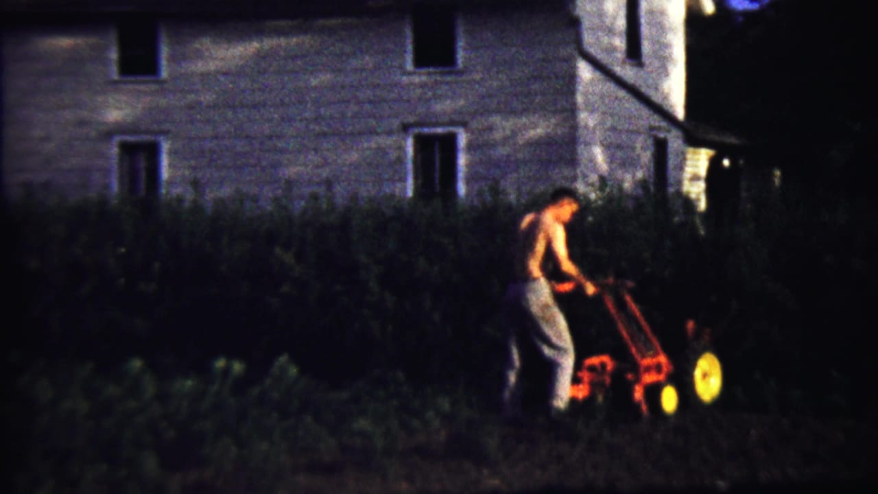 A 1958 home-movie frame shows the man standing behind the tiller, working soil near dense foliage and a modest Kansas house.