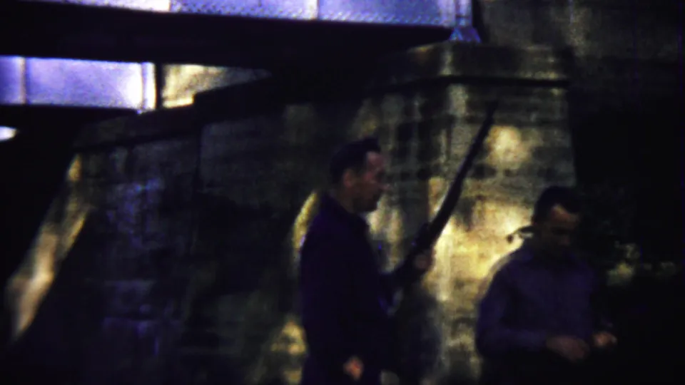 At the end of the clip, the men separate near the bridge wall in the dim 1958 Saint Francis, Kansas home-movie footage.