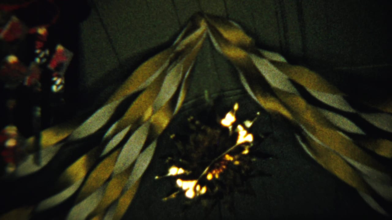 Yellow and white streamers hang in a V shape over a small glowing light.