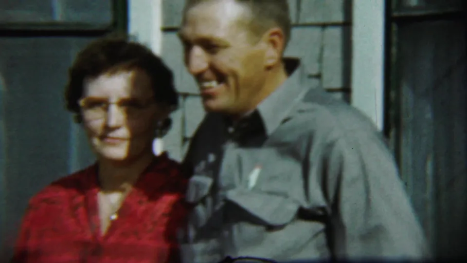 The final frame shows the Chadron couple in sunlight, posed against shingled siding with a dark residential window behind them.
