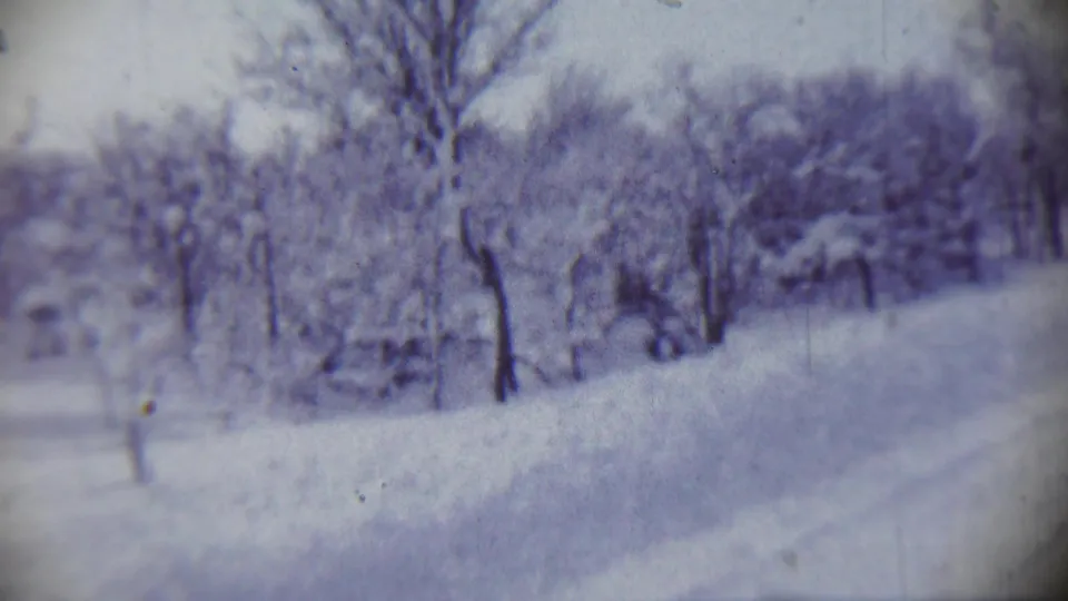 1959 Chadron, Nebraska winter landscape with snow-laden ground, bare trees, and a faint path or roadside softened by vintage 8mm exposure.