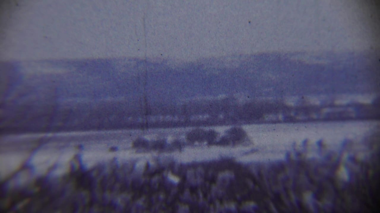 Snow-covered rural landscape near Chadron, Nebraska, with distant hills and a hazy winter sky in 1959 home-movie footage.