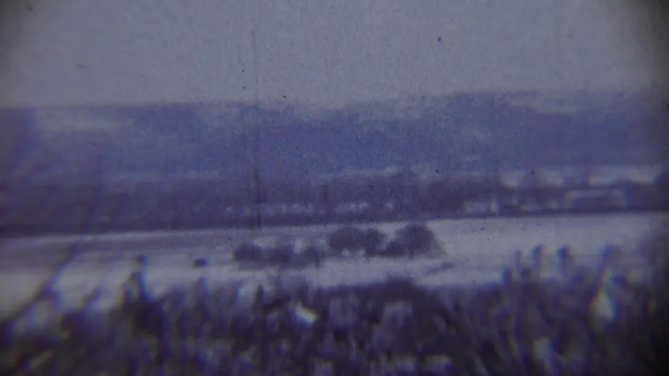 Snow-covered rural landscape near Chadron, Nebraska, with distant hills and a hazy winter sky in 1959 home-movie footage.