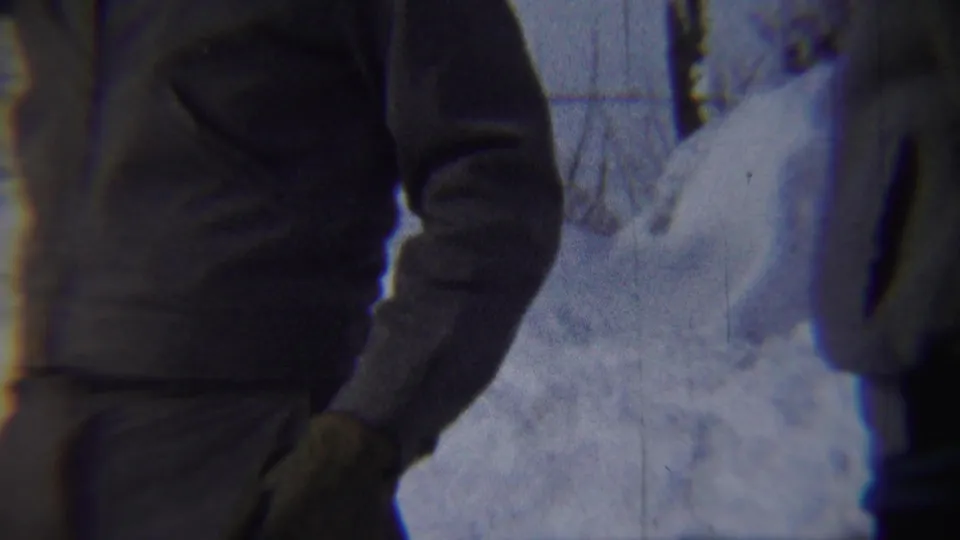 A partial person in light winter clothing appears at the edge of the 1959 Chadron snow scene, with deep snow and trees behind them.