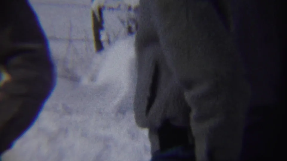 A bundled adult man partly fills the right side of the frame, with deep Chadron winter snow visible behind him.