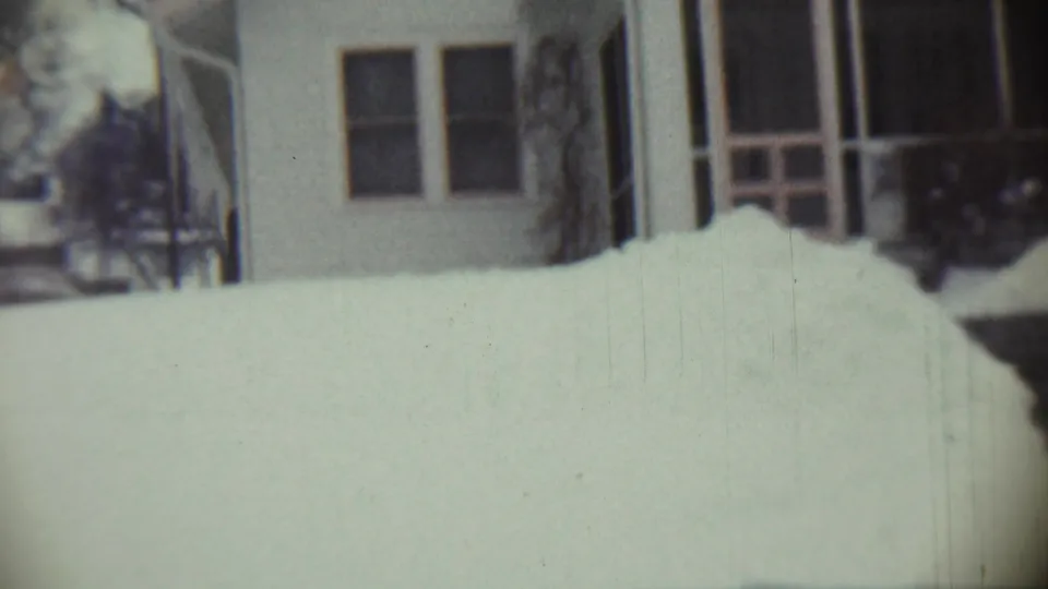 1959 Chadron, Nebraska home-movie view of a snow-covered residential yard and house front with porch details.