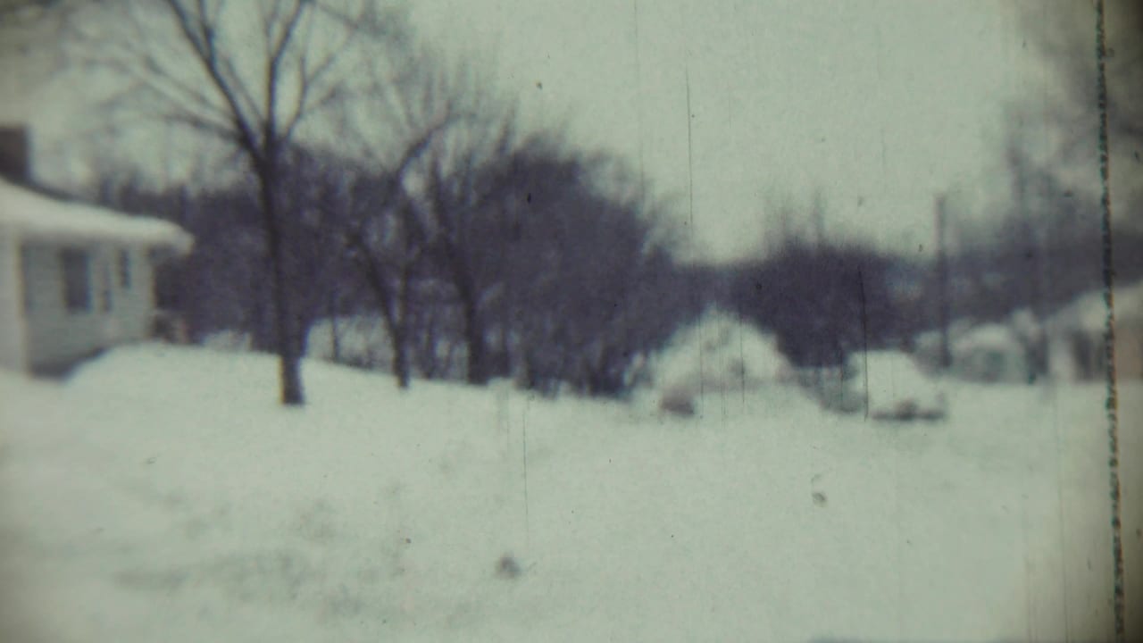 1959 Chadron, Nebraska view across a snow-blanketed neighborhood with bare trees and low houses partly obscured by drifts.