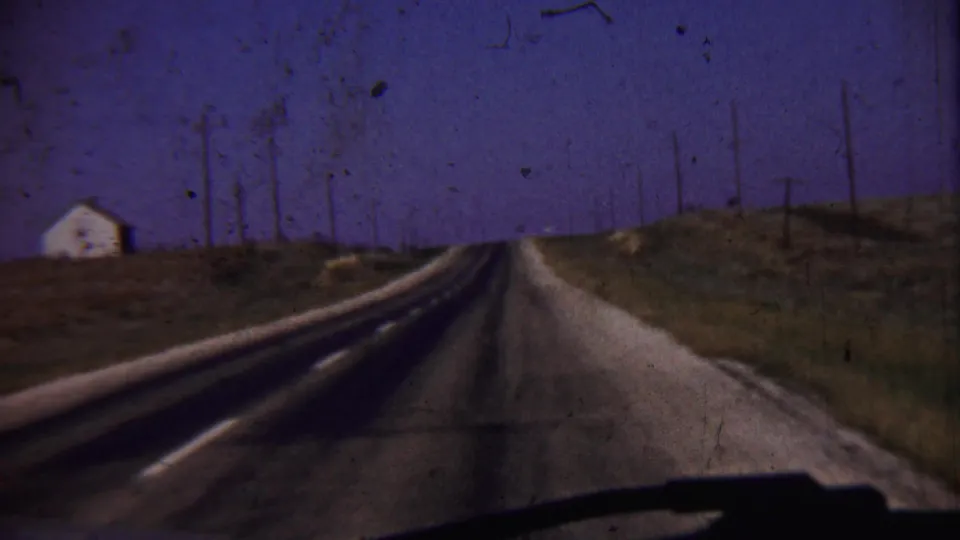 1959 home-movie road footage in rural Cheyenne County, Kansas, looking ahead from a car along an empty two-lane route.