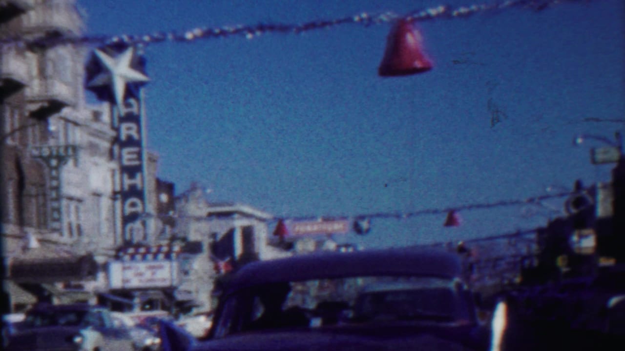 Saint Francis, Kansas street scene from 1959 with classic cars, overhead decorations, and the Wareham theater sign.