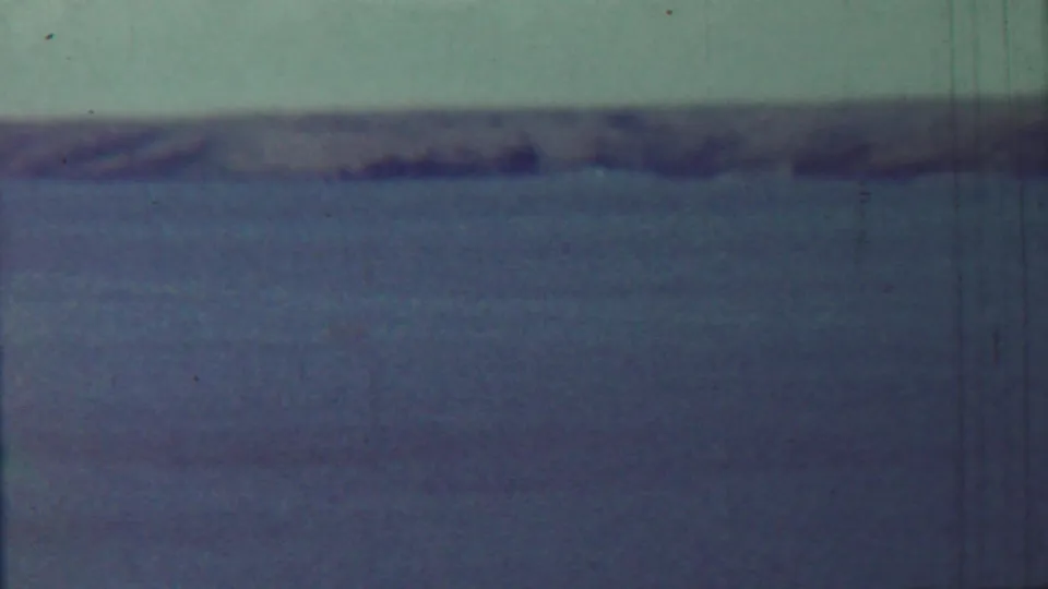 1959 Saint Francis, Kansas home-movie view of calm water and a blurred low shoreline under pale sky.