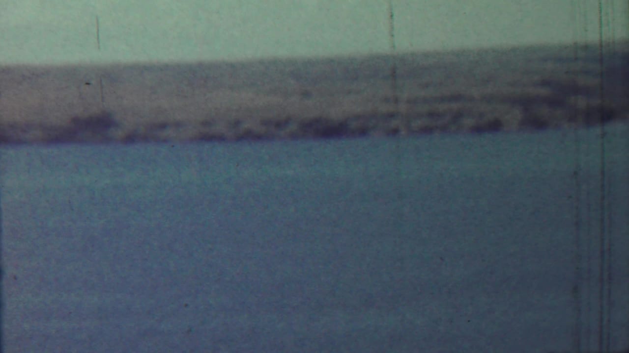 1959 8mm home-movie frame from the Saint Francis, Kansas metadata showing calm water and a blurred far shoreline.