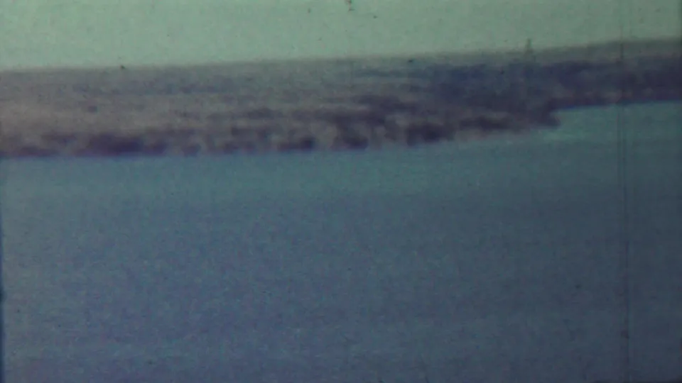 Soft 1959 lake view associated with Saint Francis, Kansas, with blue-green water and a hazy distant bank.