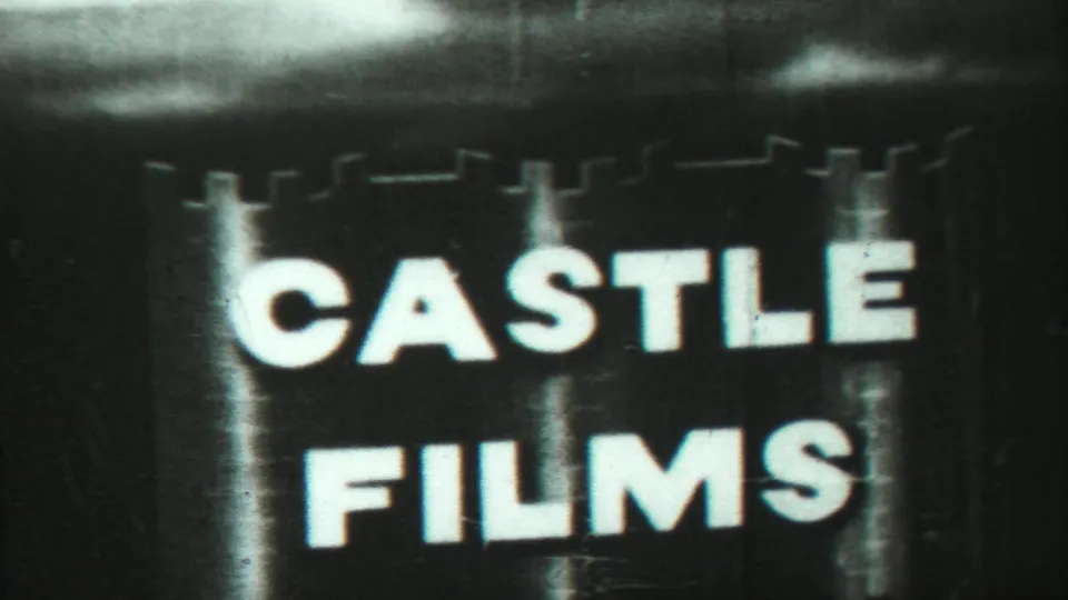 High-contrast photographed title card reading Castle Films, shown within grainy 8mm home-movie footage.