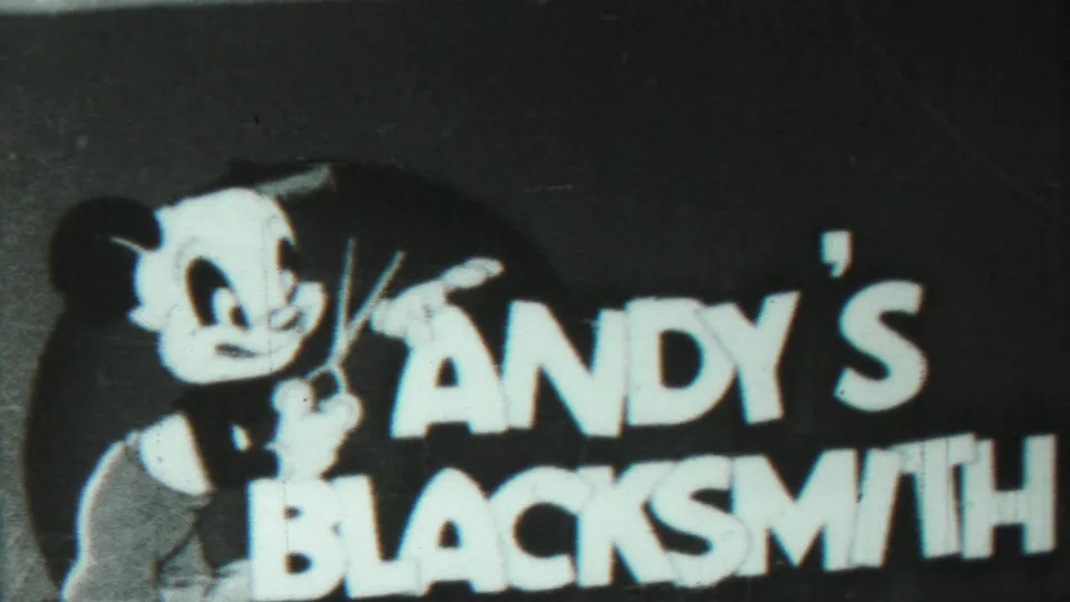 Photographed Andy's Blacksmith title card with a cartoon figure and bold lettering in a 1959 home-movie sequence.