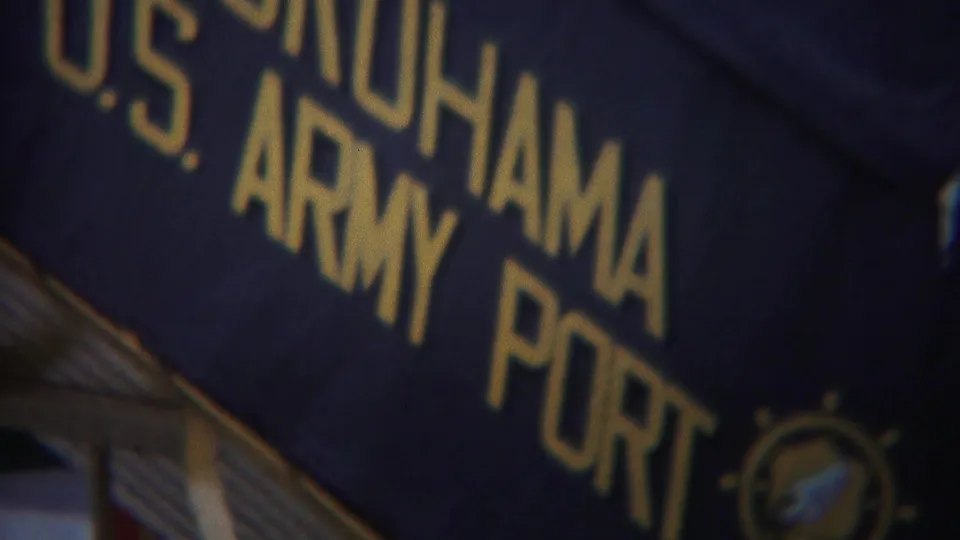 Yokohama U.S. Army Port sign fills the frame, with gold letters and a partial circular emblem visible.