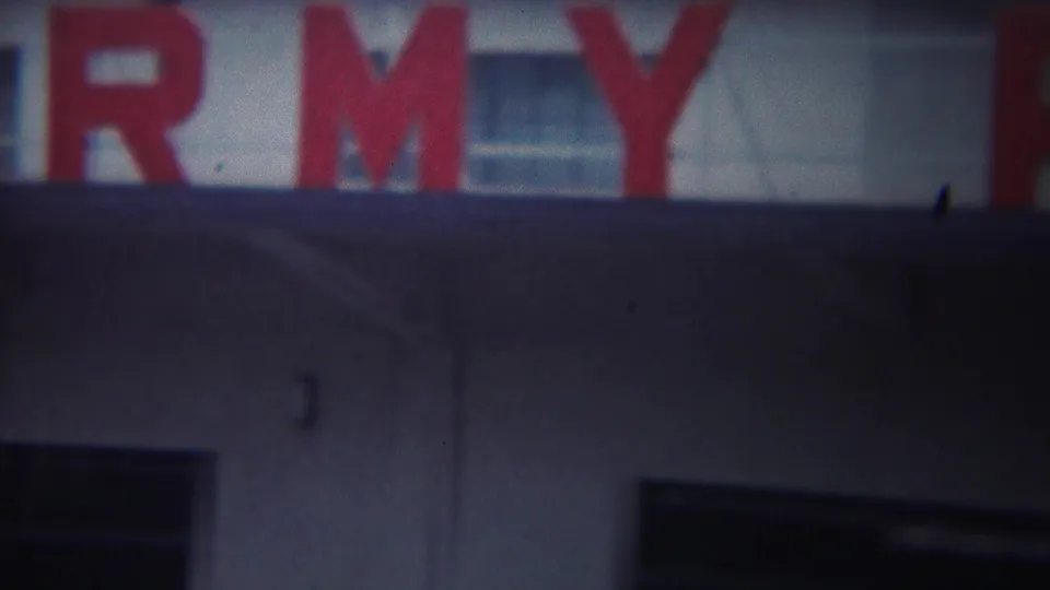 Soft 8mm frame from Yokohama showing cropped red Army Port lettering on a building exterior.
