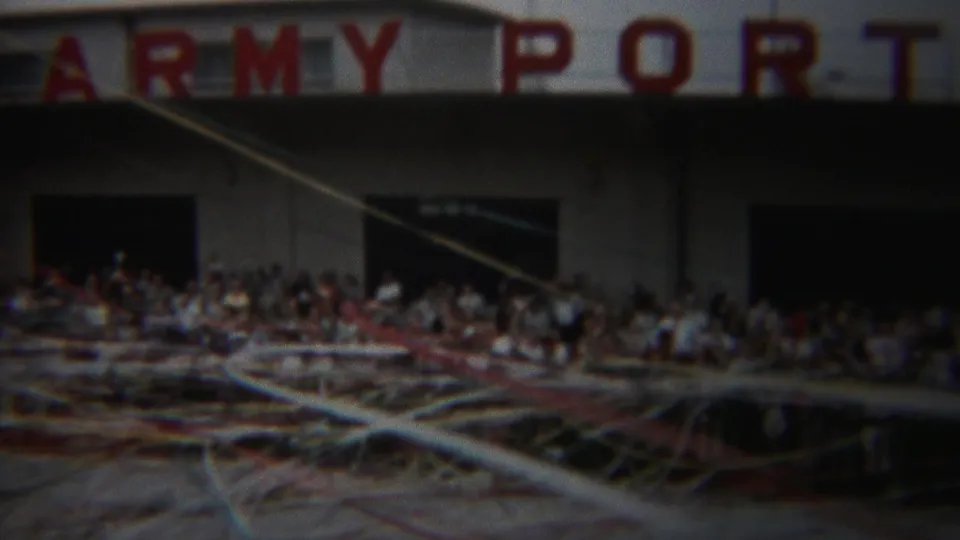 1954 Yokohama crowd scene below ARMY PORT signage, filmed through loose streamers in soft 8mm color.
