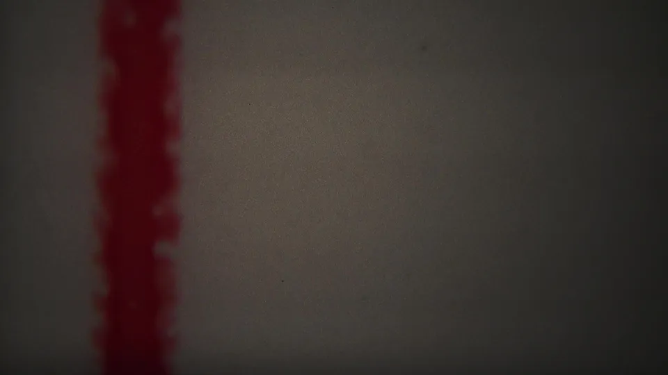 1967 Yellowstone-labeled 8mm frame showing a red vertical zigzag mark against a pale, softly vignetted background.