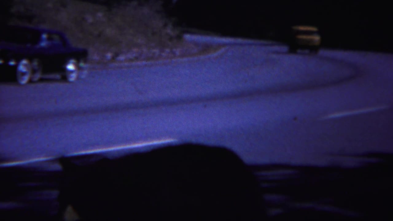 A 1967 Yellowstone road scene shows classic cars passing while a bear appears as a dark shape near the lower frame.