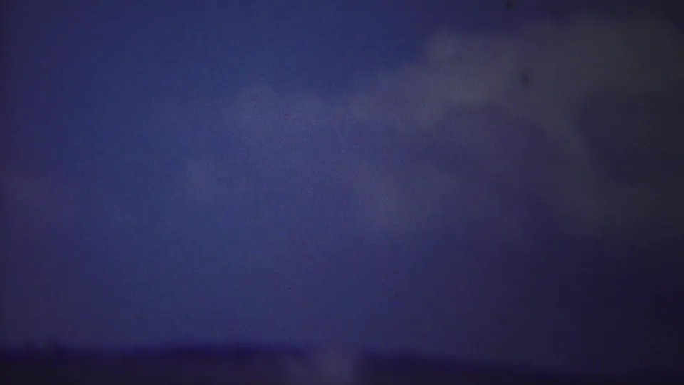 A soft 8mm view of Old Faithful's steam cloud fills much of the Yellowstone frame, with the horizon barely visible.