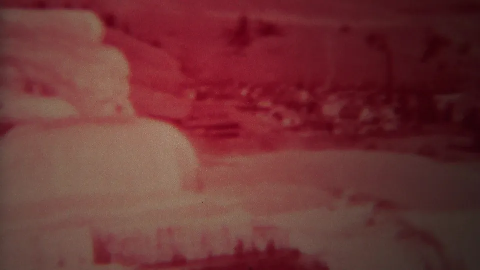 Pale Mammoth-area terrace formations and surrounding Yellowstone landscape appear in a soft, red-shifted 1967 8mm frame.