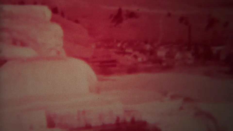 Yellowstone terrace formations and distant terrain remain visible in the final red-faded 8mm home-movie frame.
