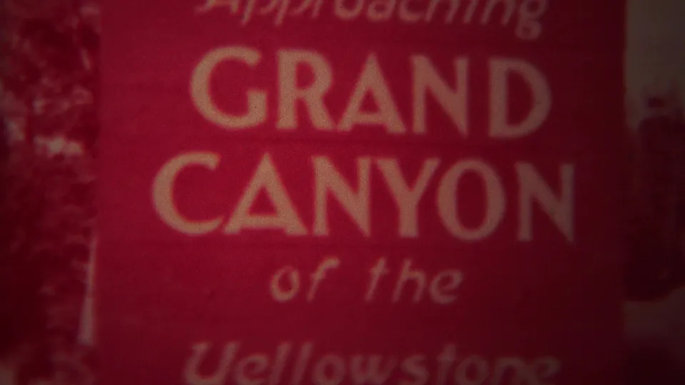1967 home-movie title card with white lettering reading Approaching Grand Canyon of the Yellowstone.