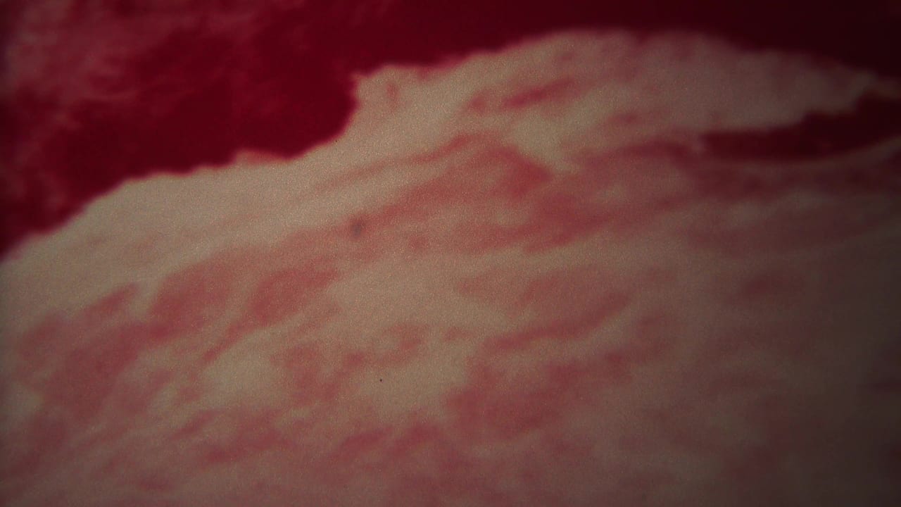 1967 Yellowstone 8mm frame showing churning water under a heavy red color shift, with pale foam and soft film grain.