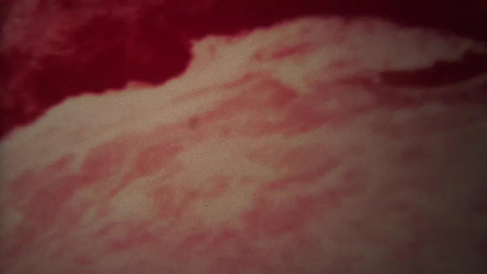 1967 Yellowstone 8mm frame showing churning water under a heavy red color shift, with pale foam and soft film grain.