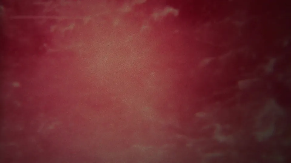 1967 Yellowstone 8mm frame filled by rushing red-pink water, pale streaks, soft blur, and visible film grain.