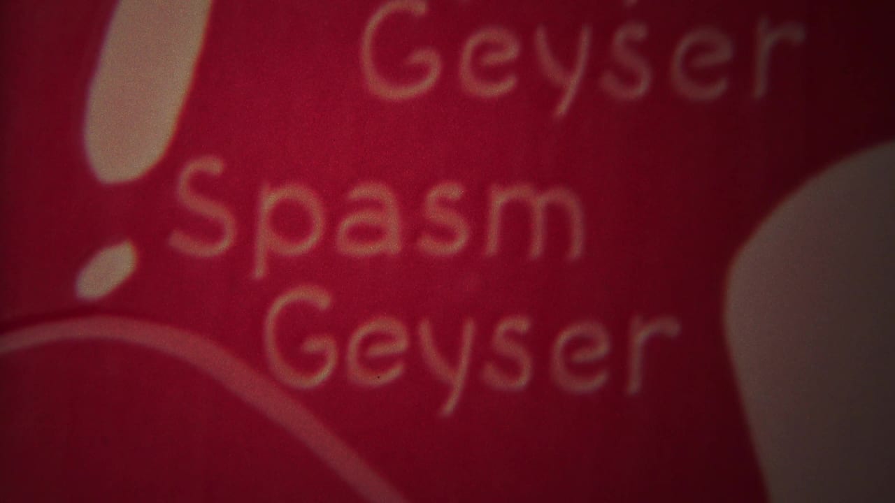 Red surface with soft yellow words reading Geyser, Spasm, and Geyser.