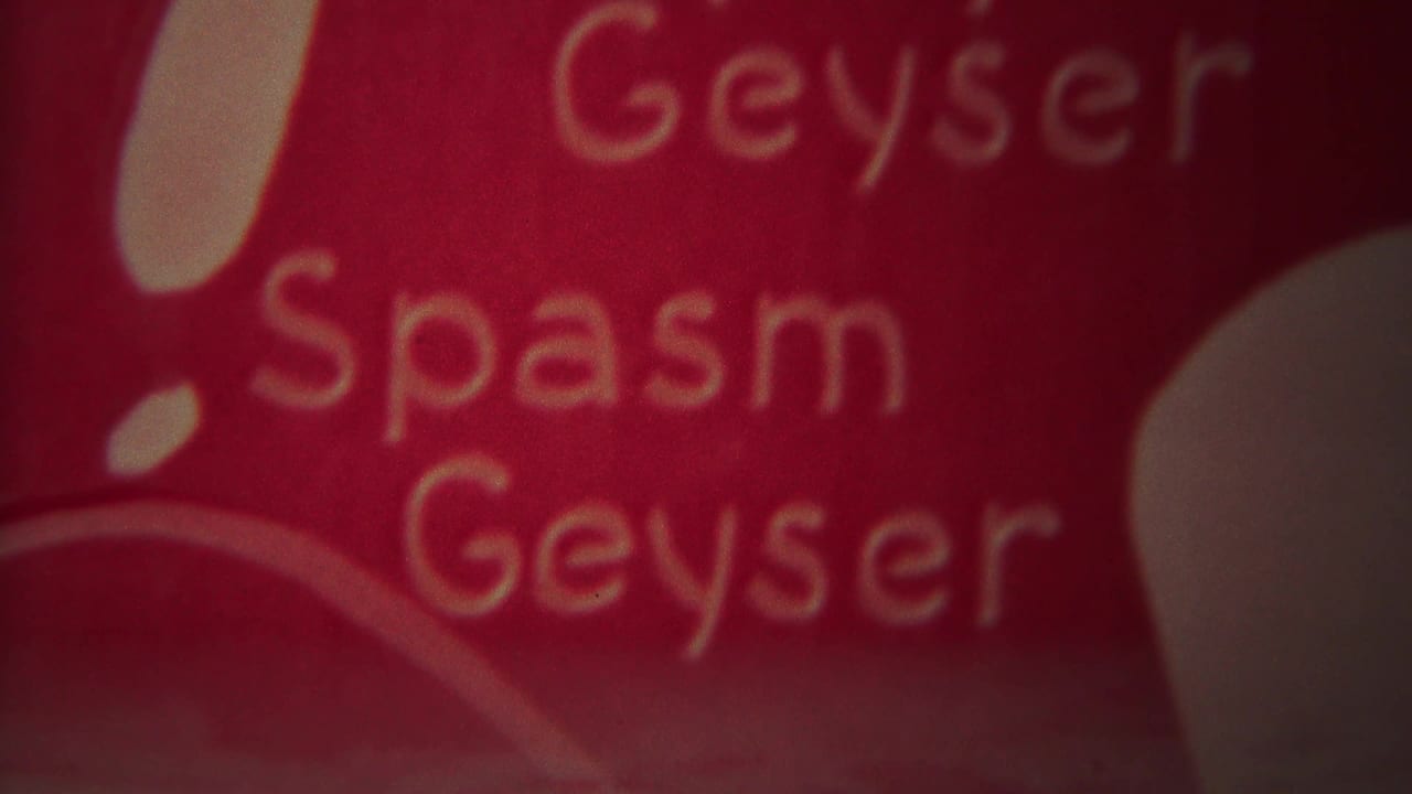 Red close-up with the words Spasm and Geyser visible in soft focus.
