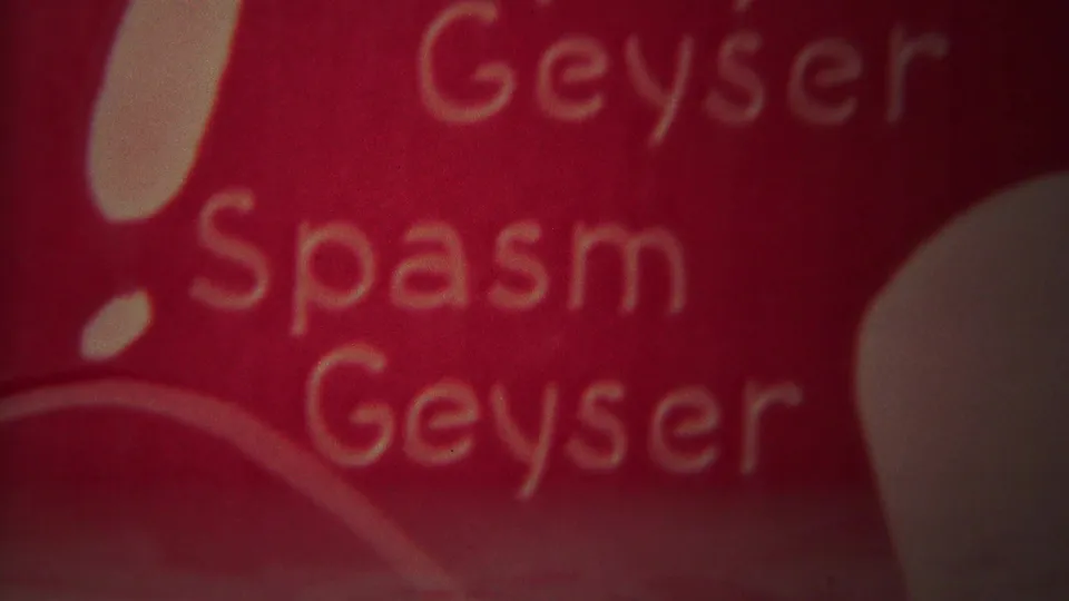 Close 8mm frame of the red Geyser Spasm Geyser wording before the eruption view.