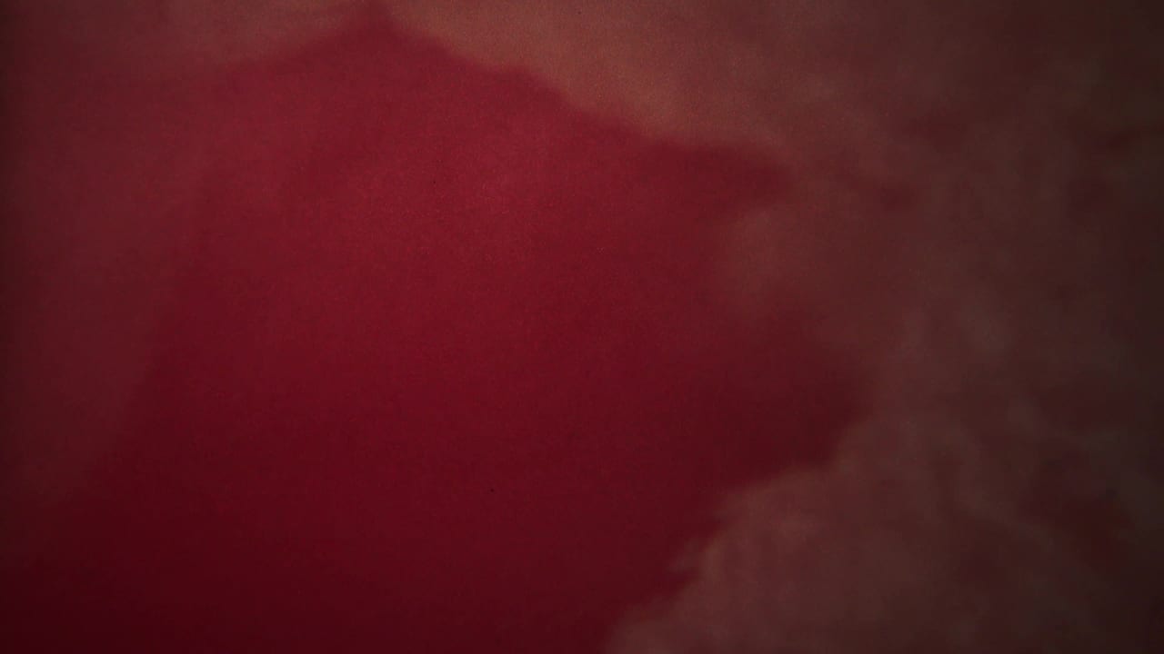 Dark red haze with a faint vertical plume form near the right side.