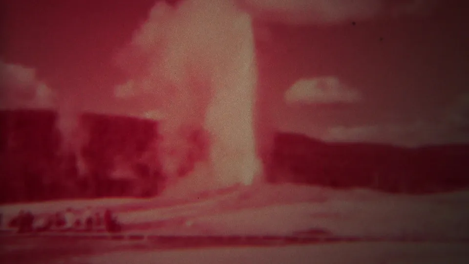 Late frame from the 1967 Yellowstone 8mm clip with Old Faithful still erupting under scattered clouds.